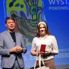 Nagrodę wręcza zastępca prezydenta Torunia Adam Szponka