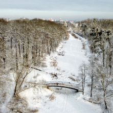 Widok z drona na ośnieżony Park Miejski i mostek na Martówce